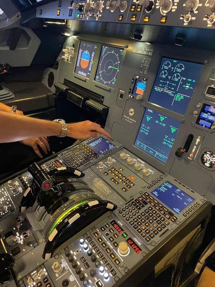 Pilot operating the controls of an Airbus A320 flight simulator
